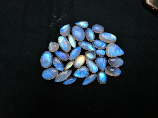 506.35 Cts Fine Quality of White Rainbow Moonstone Mix shaped smooth cabochons Wholesale Sample lot / parcel, 30 Pieces
